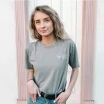 A girl wearing the premium unisex t-shirt, which is the most popular t-shirt style.