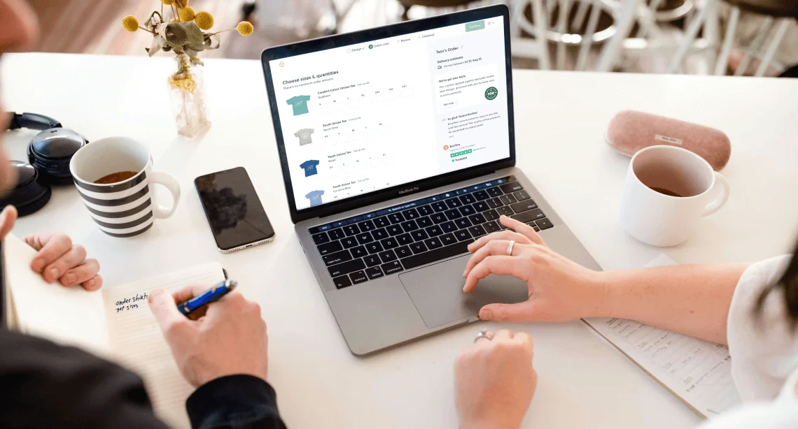 Customer is in the process of ordering group tees on a laptop