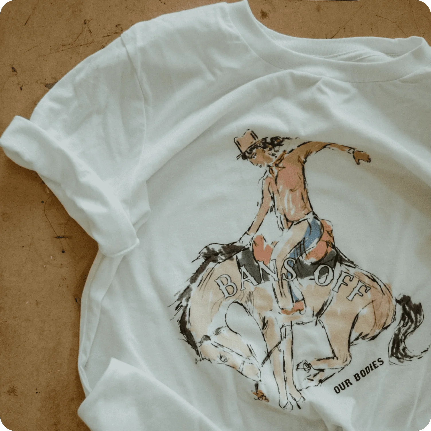 T-shirt featuring hand-drawn cowboy illustration with expressive, sketch-like linework.