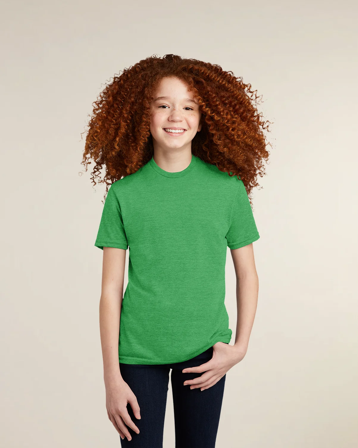 A youth model wearing a green eco-friendly triblend t-shirt from Allmade.