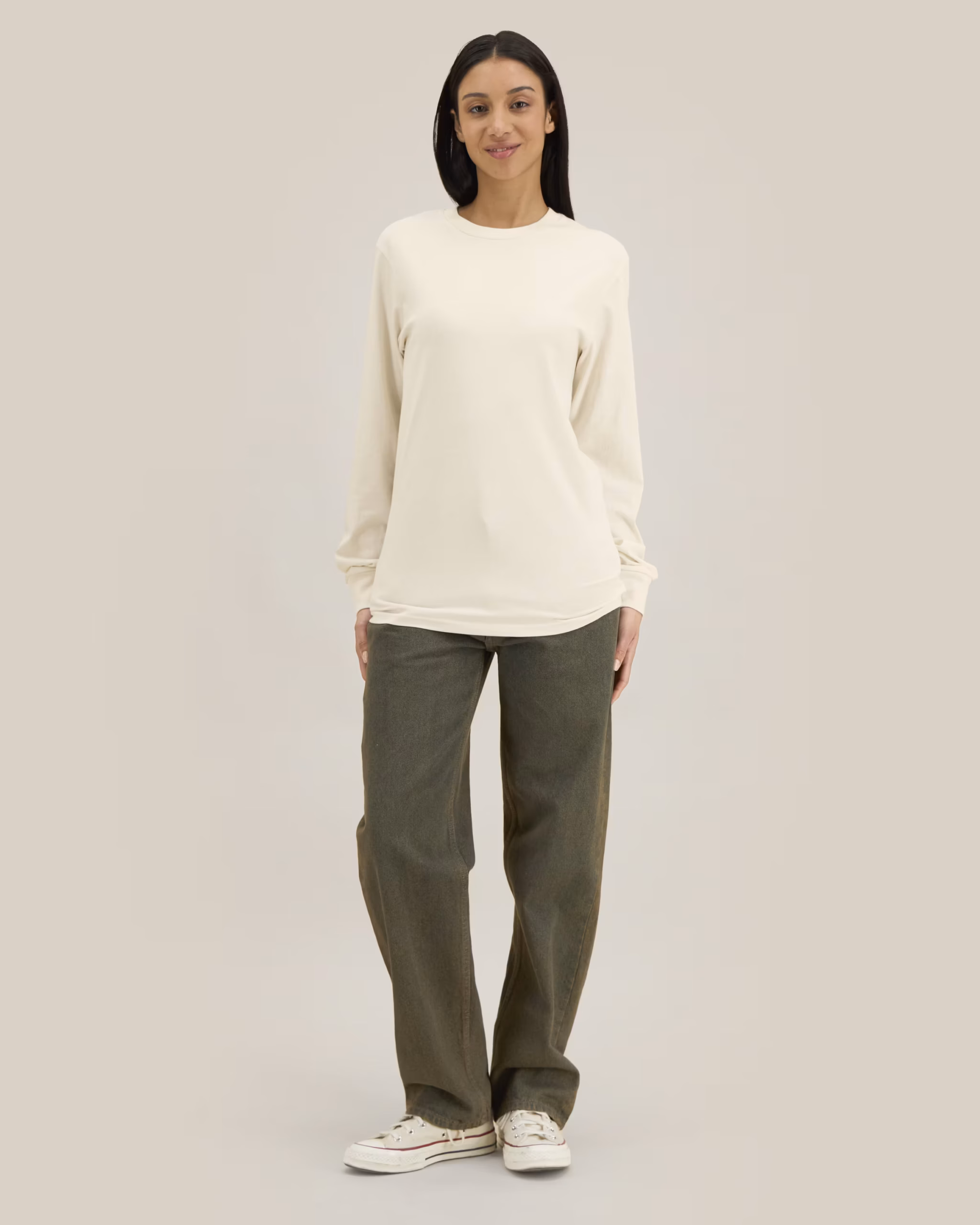 Female model wearing a Stanley/Stella Creator 2.0 Long Sleeve Tee in Natural Raw.