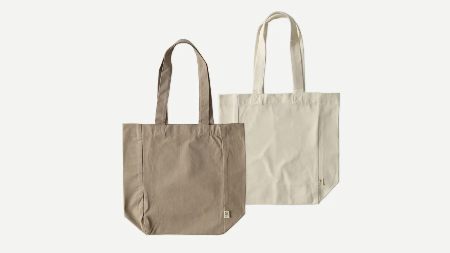 Two eco-friendly canvas tote bags from Econscious in natural colors.